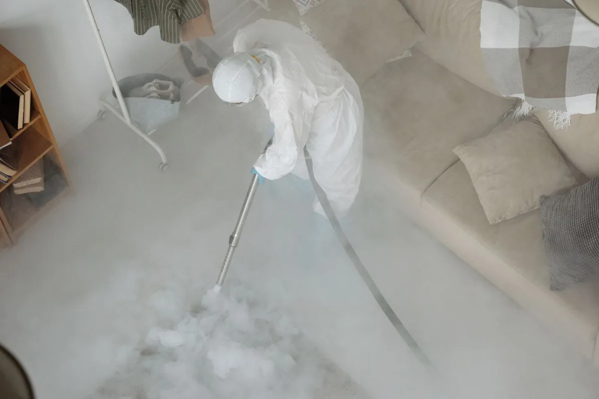 Biohazard cleanup technician in protective equipment, Genoa, AR
